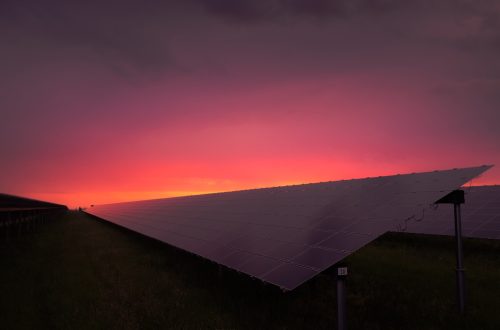 black solar panel under red and gray clouds