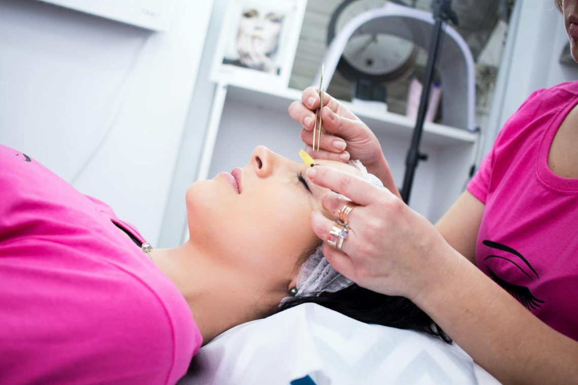 A woman receiving a relaxing facial treatment in a beauty salon.