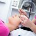 A woman receiving a relaxing facial treatment in a beauty salon.